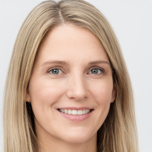 Joyful white young-adult female with long  brown hair and green eyes