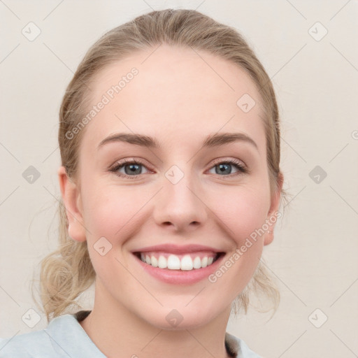 Joyful white young-adult female with medium  brown hair and blue eyes