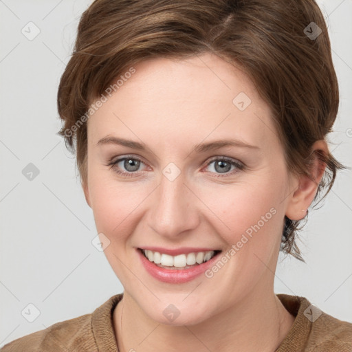 Joyful white young-adult female with medium  brown hair and blue eyes