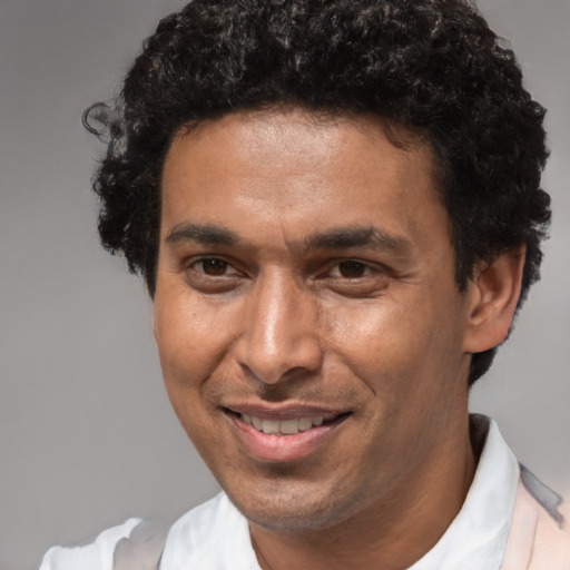 Joyful black adult male with short  brown hair and brown eyes