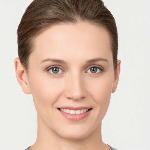 Joyful white young-adult female with short  brown hair and grey eyes