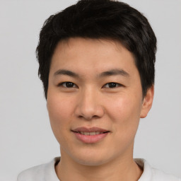 Joyful asian young-adult male with short  brown hair and brown eyes