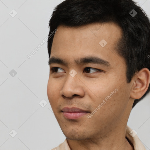 Joyful asian young-adult male with short  black hair and brown eyes