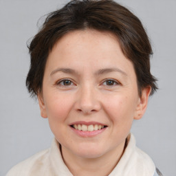 Joyful white adult female with short  brown hair and brown eyes