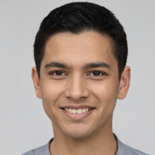 Joyful white young-adult male with short  black hair and brown eyes
