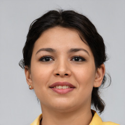 Joyful asian young-adult female with medium  brown hair and brown eyes