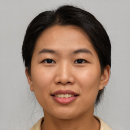 Joyful asian young-adult female with medium  brown hair and brown eyes