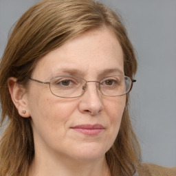 Joyful white adult female with long  brown hair and blue eyes