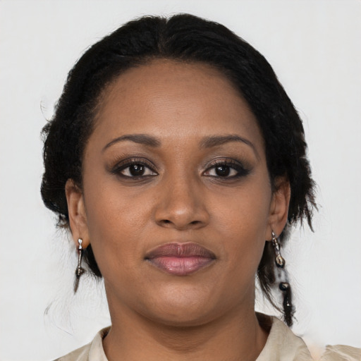 Joyful black adult female with medium  black hair and brown eyes