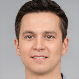 Joyful white young-adult male with short  brown hair and brown eyes