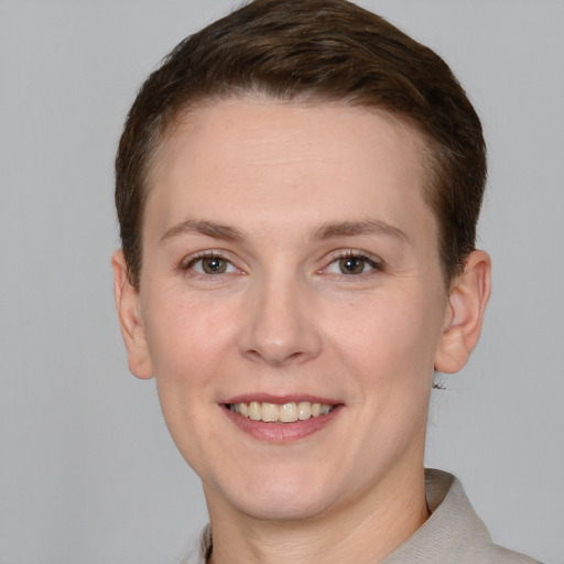 Joyful white adult female with short  brown hair and grey eyes