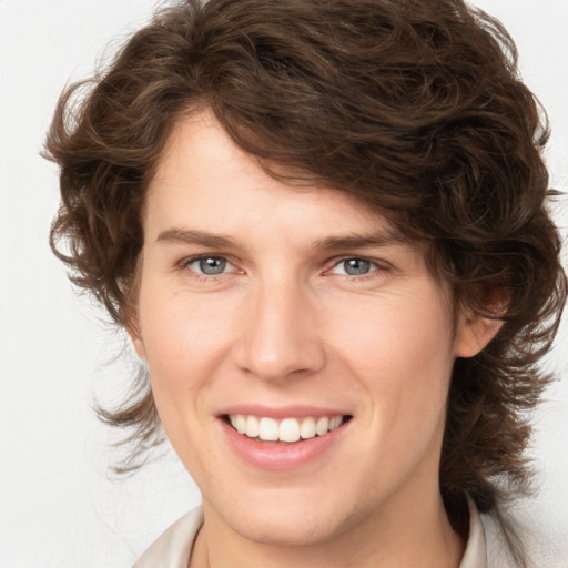 Joyful white young-adult female with medium  brown hair and blue eyes