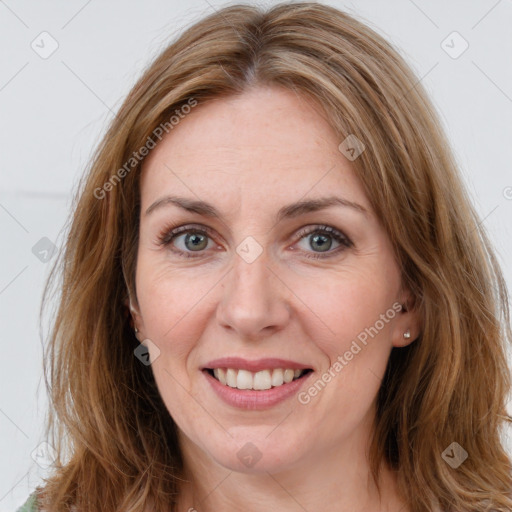 Joyful white adult female with long  brown hair and brown eyes