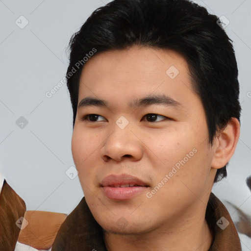 Joyful asian young-adult male with short  black hair and brown eyes