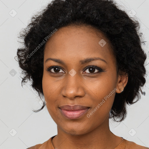 Joyful black young-adult female with long  black hair and brown eyes