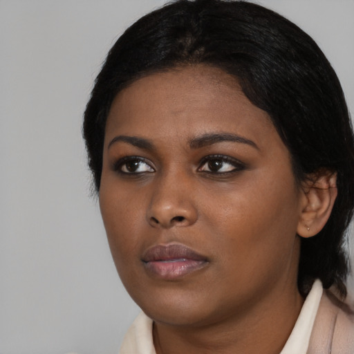 Neutral black young-adult female with medium  black hair and brown eyes