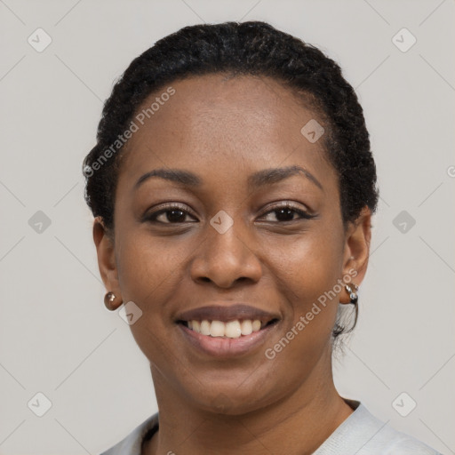 Joyful black young-adult female with short  black hair and brown eyes