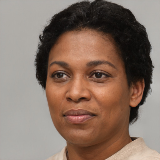 Joyful black adult female with short  black hair and brown eyes