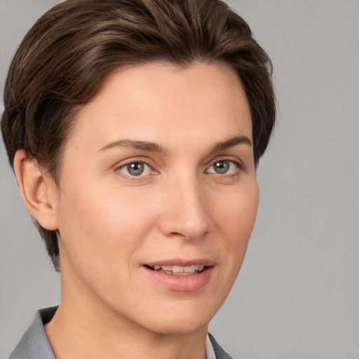 Joyful white young-adult female with short  brown hair and grey eyes