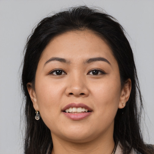 Joyful asian young-adult female with long  brown hair and brown eyes