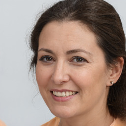 Joyful white adult female with medium  brown hair and brown eyes