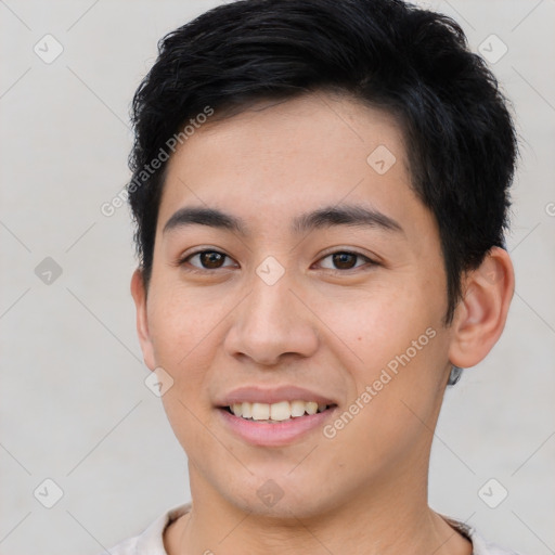 Joyful asian young-adult male with short  black hair and brown eyes