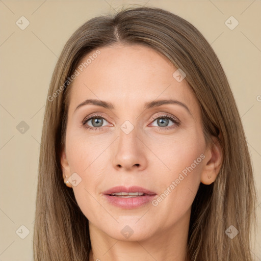 Joyful white adult female with long  brown hair and grey eyes