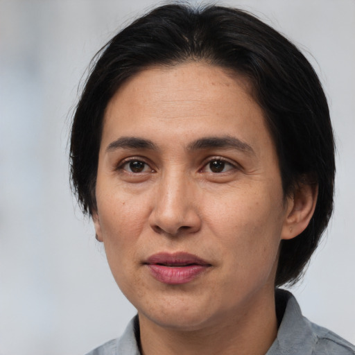 Joyful white adult female with medium  brown hair and brown eyes