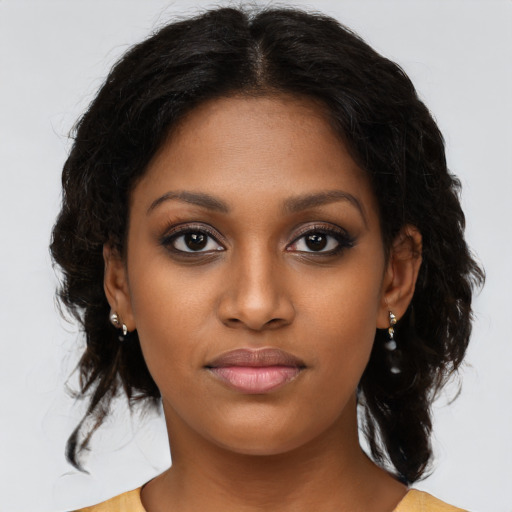 Joyful black young-adult female with medium  brown hair and brown eyes