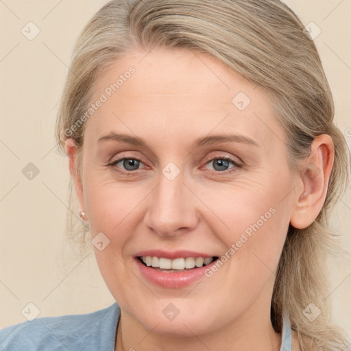 Joyful white adult female with medium  brown hair and blue eyes