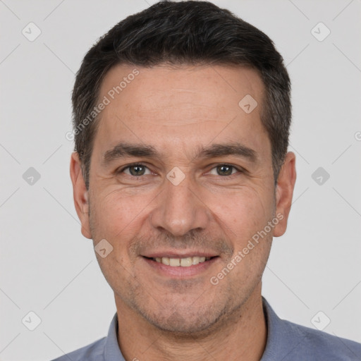 Joyful white adult male with short  brown hair and brown eyes