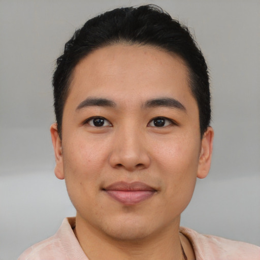 Joyful asian young-adult male with short  brown hair and brown eyes