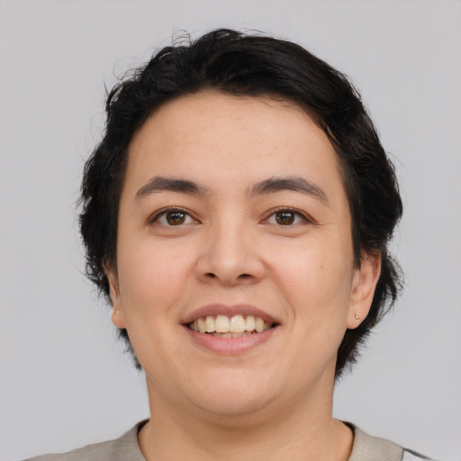 Joyful white young-adult female with short  black hair and brown eyes