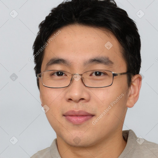 Joyful asian young-adult male with short  black hair and brown eyes