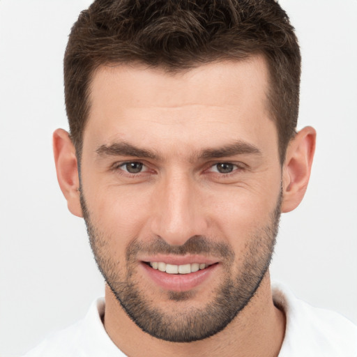 Joyful white young-adult male with short  brown hair and brown eyes