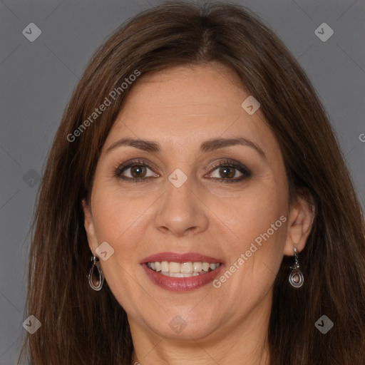 Joyful white adult female with long  brown hair and brown eyes