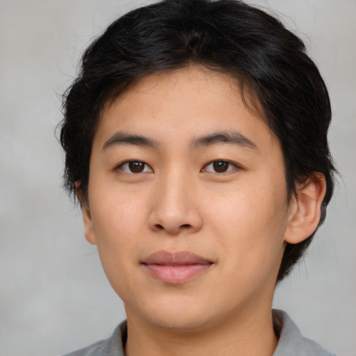 Joyful asian young-adult male with medium  brown hair and brown eyes