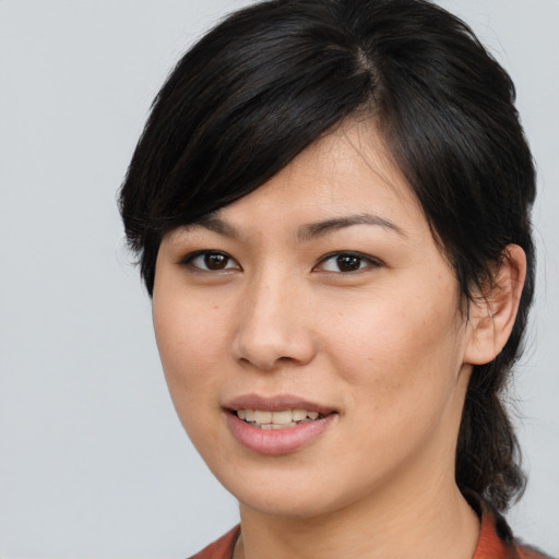 Joyful asian young-adult female with medium  brown hair and brown eyes