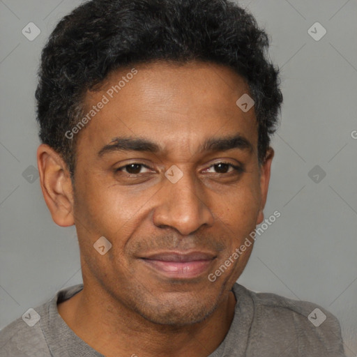 Joyful black adult male with short  brown hair and brown eyes