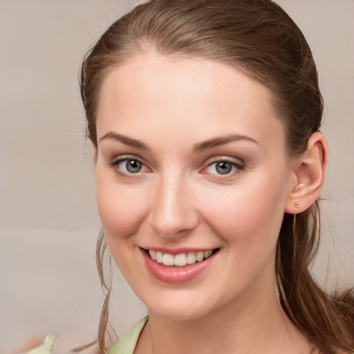 Joyful white young-adult female with long  brown hair and grey eyes