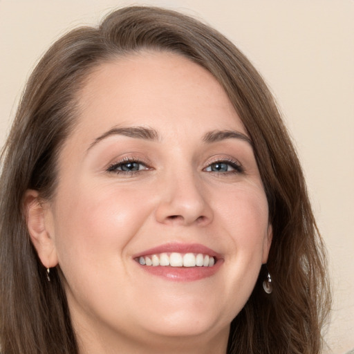 Joyful white young-adult female with long  brown hair and grey eyes