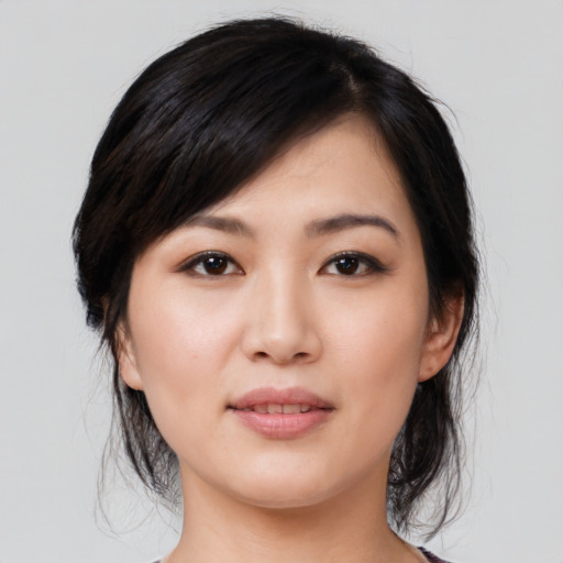 Joyful asian young-adult female with medium  black hair and brown eyes