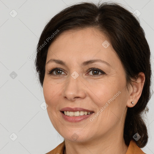 Joyful white adult female with medium  brown hair and brown eyes