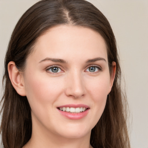 Joyful white young-adult female with long  brown hair and grey eyes