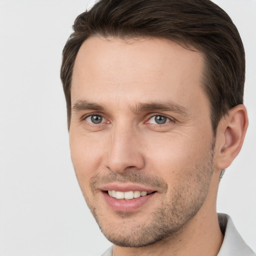 Joyful white young-adult male with short  brown hair and brown eyes