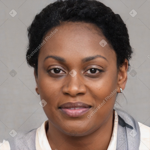 Joyful black young-adult female with short  black hair and brown eyes