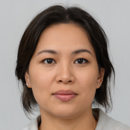 Joyful asian young-adult female with medium  brown hair and brown eyes