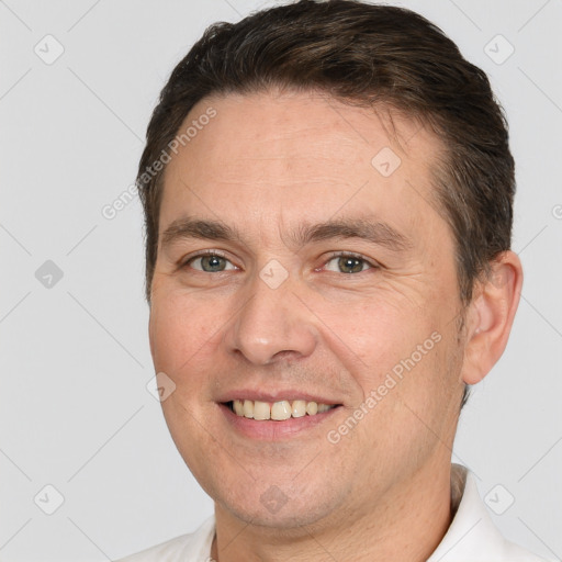 Joyful white adult male with short  brown hair and brown eyes