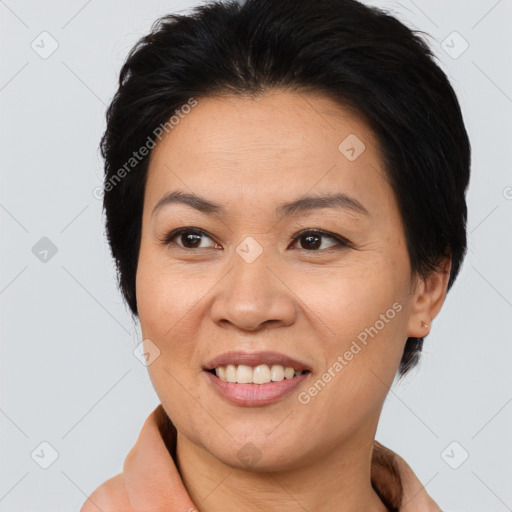 Joyful asian adult female with medium  brown hair and brown eyes