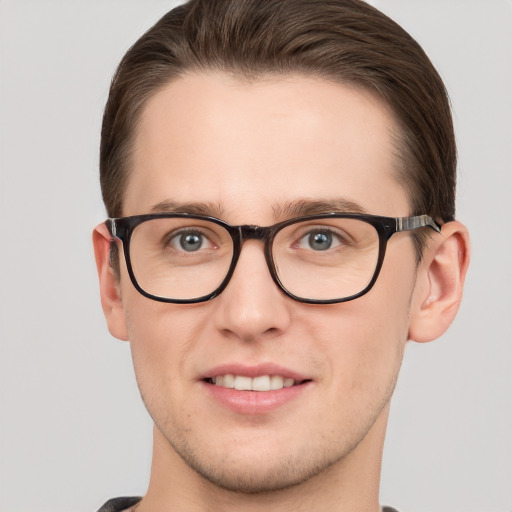 Joyful white young-adult male with short  brown hair and grey eyes